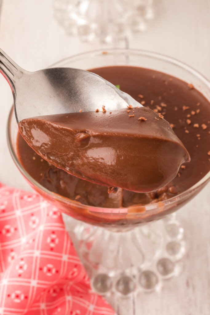 scooping chocolate pudding out of bowl onto spoon