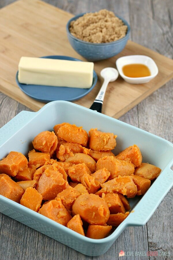 Learn how to make candied yams for your next family meal, it's so simple! This candied sweet potatoes recipe is easy and delicious! Image shows the first step in making candied yams recipe in a casserole dish.