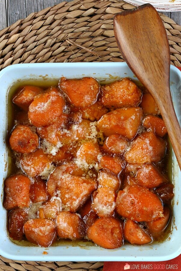 Learn how to make candied yams for your next family meal, it's so simple! This candied sweet potatoes recipe is easy and delicious! A top down view of the finished yam recipes ready to be eaten and served.